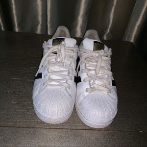 White and black shell toes shoes
